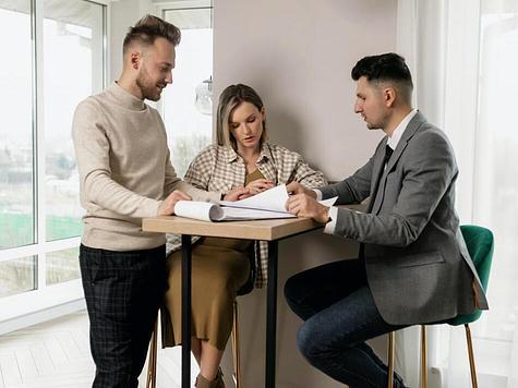 Couple reviewing documents with a real estate agent.