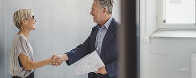 Real estate professional shaking hands with a client.
