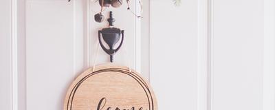 Front door with a ‘welcome’ sign.