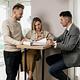 Couple reviewing documents with a real estate agent.