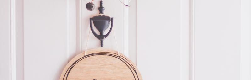 Front door with a ‘welcome’ sign.