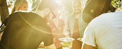 Group of friends enjoying a meal together in their backyard.