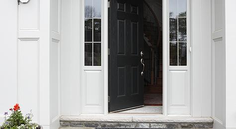Partially open front door of a home.