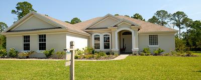 Single-story house with a for-sale sign in the yard.